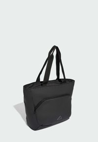 Svart nylon strandväska med dubbla handtag, en framficka med dragkedja och en diskret logotypdetalj. Slät textur och rektangulär form.