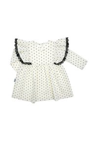 Biała sukienka z czarnymi groszkami, długimi rękawami i marszczonym dekoltem wykończonym czarną koronką. Zapięcie z tyłu na guziki.