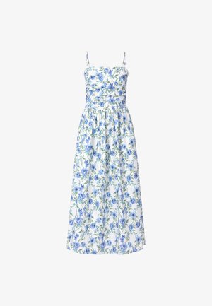 Bloementuniek met blauwe en groene patronen op een witte achtergrond, met spaghetti bandjes en een aansluitend lijfje. Vloeiende, knielange rok.