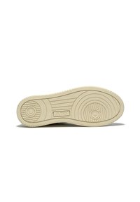 Suela de zapatilla de goma beige con patrones de textura circulares y lineales, con el logotipo de la marca "AUTRY" estampado en la superficie.