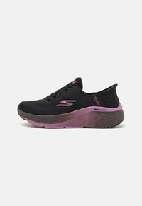 Black athletic shoe with a breathable mesh upper, pink midsole, textured outsole, and a prominent "S" logo on the side.