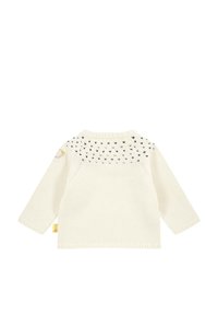Maglione lavorato a maglia color crema con maniche lunghe, caratterizzato da un motivo di piccoli cuori neri sulla spalla e un elemento decorativo sulla spalla.