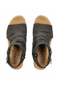 Black fabric sandals with a ruched design, a closed back, and side zippers. The sole is tan, with a textured finish. "Blowfish Malibu" is printed inside.