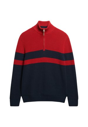 Pull à col zippé rouge et bleu marine avec texture côtelée, présentant des rayures horizontales et un col montant. En mélange de coton.