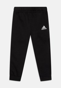 Juodos medvilnės patalynės kelnes, pagamintas iš mišinių, su elastinga juosmens juosta ir sutrauktais kulkšnimis. Balta Adidas logotipas viršutiniame kairiajame gole.