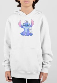 Sudadera blanca con un estampado de un personaje de dibujos animados en azul y púrpura en la parte frontal, con grandes orejas rosas y una expresión juguetona.