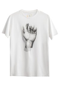 T-shirt en coton blanc avec un graphique noir et blanc d'une main ouverte à l'avant. Manches courtes et encolure ronde.