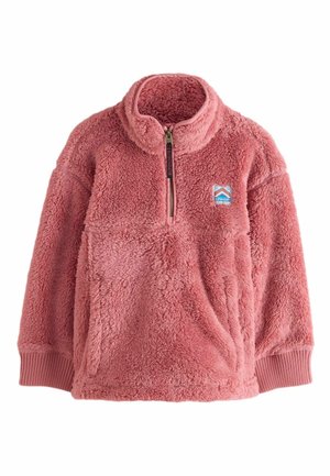 Suma vaaleanpunainen neule, jossa on puolivetoketju kauluksessa, etutasku, ribbireunat ja brodeerattu lappu vuoristologolla rinnassa.