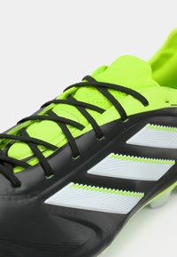 Black and neon green soccer cleat with black laces and three white Adidas stripes on the side.