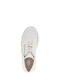 White leather sneaker with a rounded toe, flat laces, side zipper, and a multi-colored woven sole featuring green, yellow, and pink accents.