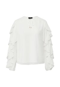 Blouse blanche à manches longues et volants, avec un détail de lien sur le devant. Fabriquée en tissu léger, elle présente une coupe décontractée et un col rond.
