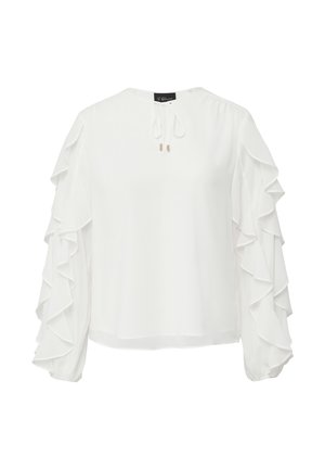 Blouse blanche à manches longues et volants, avec un détail de lien sur le devant. Fabriquée en tissu léger, elle présente une coupe décontractée et un col rond.