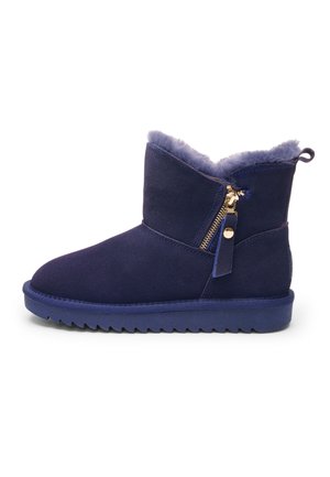 Navy blue suede ankle boot with fleece lining, side gold zipper, loop tab at heel, and ridged rubber sole.