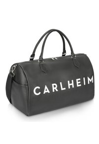 Černá syntetická taška na sport s dvojitými rukojeťmi, stříbrným zipem a velkým bílým logem "CARLHEIM" na přední straně. Hladký povrch a zakřivený tvar.