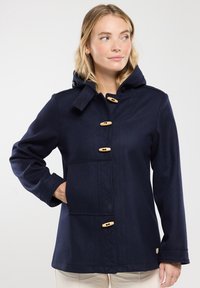 Cappotto con cappuccio di colore blu navy in misto lana, con chiusure a toggle in legno, una grande tasca frontale e dettagli di cucitura testurizzati.
