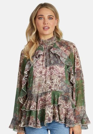 Blusa de manga larga con volantes y escote alto. Patrones florales multicolores en verde, rosa y púrpura. Tejido ligero con un ajuste fluido.