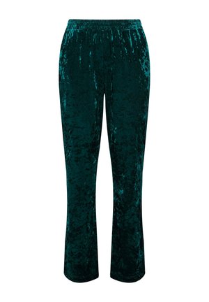 Pantaloni in velluto di colore verde teal, con cintura elastica e design a gamba affusolata, che mettono in mostra una superficie testurizzata con una leggera lucentezza.