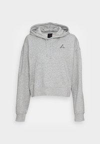 Sudadera corta de color gris claro hecha de una tela suave. Presenta un bolsillo frontal, cordones ajustables y un logo bordado en negro en el pecho.