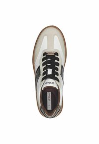 Sneaker with a white leather upper, black accents, textured brown sole, and black laces. Features a padded collar and branding on the tongue.