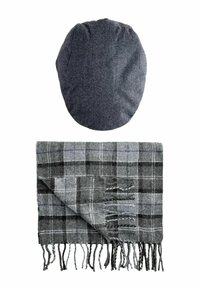 Gray herringbone-patterned cap above a gray plaid scarf with black and white accents, featuring fringed edges and soft texture.