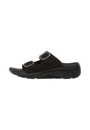 Sandalo nero con due cinturini in velcro regolabili e suola imbottita, progettato per comfort e uso casual.