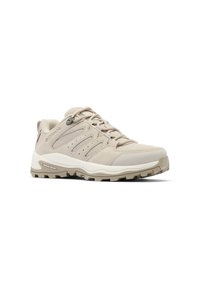 Chaussure de randonnée basse beige avec semelle texturée, dessus en mesh et suède, fermeture à lacets, et détails de marque sur le côté et la semelle.