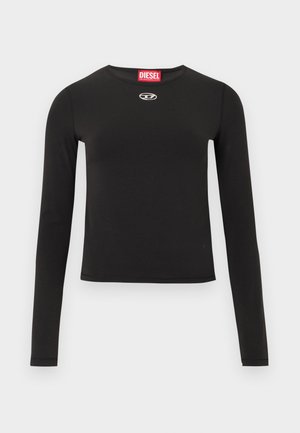 Must pikkade varrukatega särk, mis on valmistatud siledast kangast, omab ümarat kaelust, lühendatud lõiget ja väikest hõbedast logo rinnal.