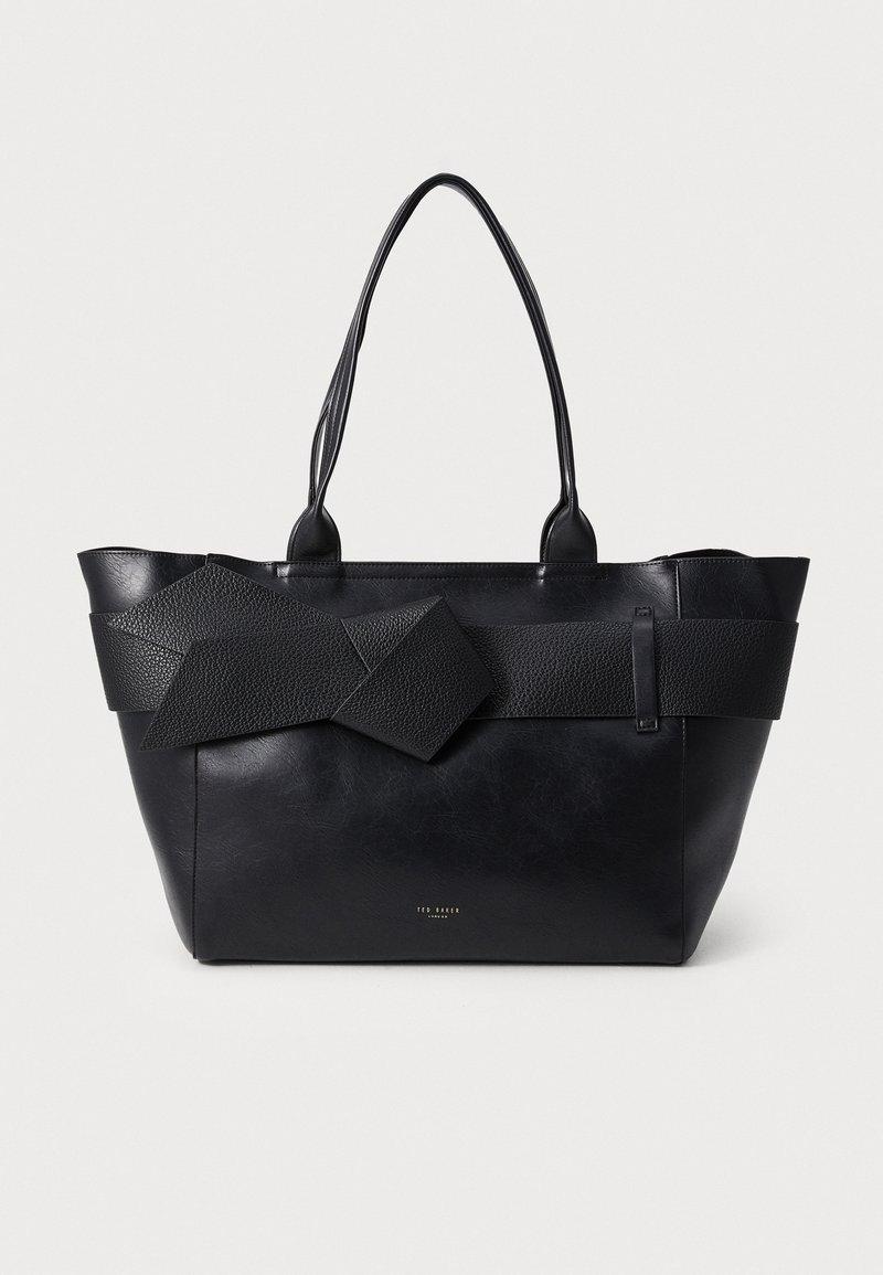 Sac cabas en cuir noir avec de longues anses et une large sangle texturée nouée en nœud sur le devant, de la marque Ted Baker.