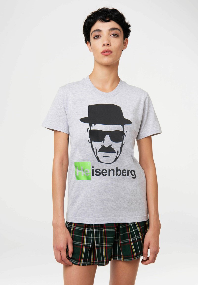 Gray cotton t-shirt featuring a black graphic of a man in a hat and sunglasses, with the text "Heisenberg" in green below.