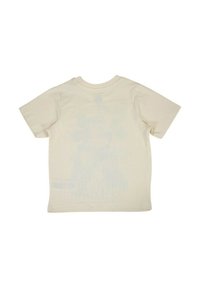 T-shirt en coton beige clair à manches courtes et col rond. Dos uni avec une texture subtile ; ne comporte aucun motif ou design.