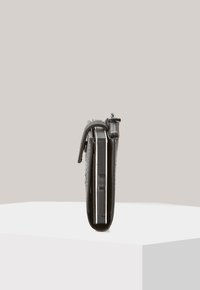 Black leather wallet with a textured surface, slim design, visible zipper opening, and horizontal orientation on a white pedestal.