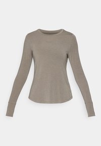 Dlouhý rukáv košile v světle hnědé tkanině, přiléhavý design s kulatým výstřihem a přišitými manžetami. Hladká textura s jemným leskem.