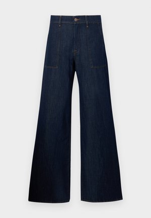 Donkerblauwe wijde jeans gemaakt van denim, met twee voorkruiszakken, zichtbare stiksels en een knoopsluiting in de taille.
