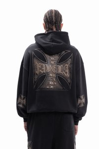 Black oversized hoodie with a large metallic cross graphic on the back. Features long sleeves and a relaxed fit. Notable textured accents.