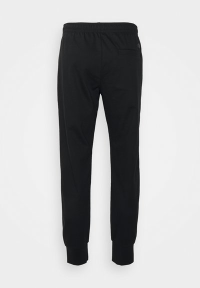 Pantalons de sport noirs à coupe ajustée, avec une taille élastique et des poignets côtelés. Dispose d'une poche arrière sur le côté droit. Texture de tissu lisse.