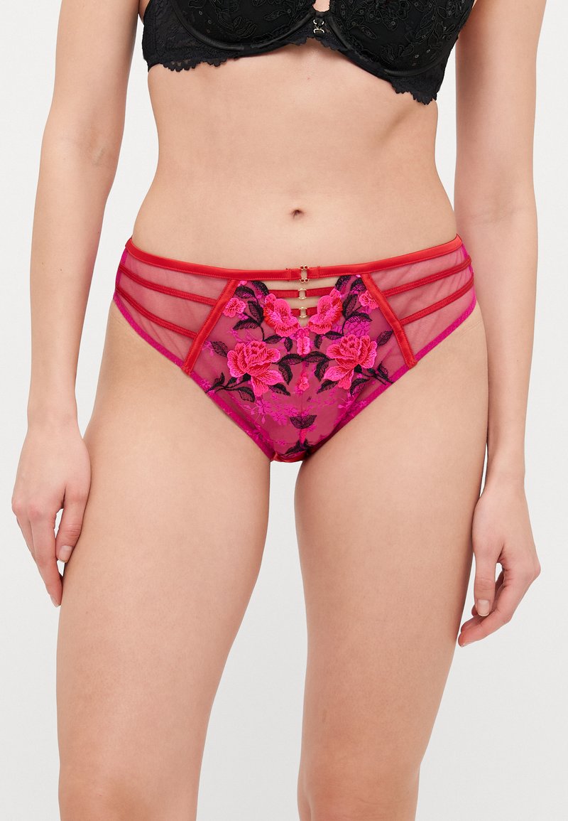 Pink mesh and embroidered floral brief with red accents and multiple side straps. Features gold hardware detail at the front.