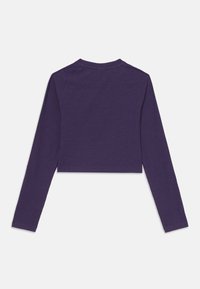 Lila, hosszú ujjú, rövid fazonú felső kerek kivágással és sima textúrával. Fitted fazonú és raglán ujjakkal rendelkezik.