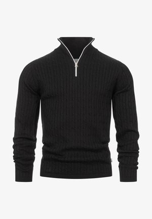 Sort strikket sweater med lynlåslukket høj krave, der har et tekstureret kabelmønster samt ribstrikkede manchetter og kant.