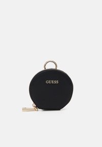 Svart cirkulärt myntfodral med strukturerad yta, guldfärgade detaljer och "GUESS"-logotyp. Har en dragkedja och en nyckelring.