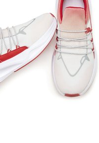 White mesh sneakers with red accents, featuring gray design lines and reflective laces. Lightweight sole with textured patterns.