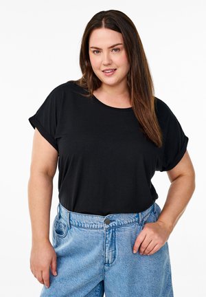 Black short-sleeve t-shirt with rolled cuffs, paired with light blue high-waisted denim shorts featuring a button closure and a relaxed fit.