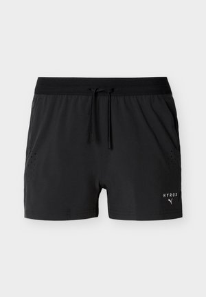 Black athletic shorts with elastic waistband and drawstring, side pockets, perforated ventilation details, and white HYROX Puma logo on right leg.