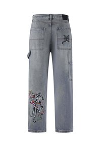 Gray denim cargo pants featuring embroidered dog and snake design, multiple patch pockets, and subtle fading. Adjustable side strap detail.