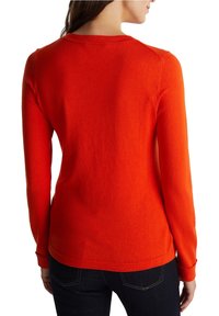 Red knit sweater, long sleeves, round neckline, ribbed cuffs and hem. Smooth texture, fitted design, no visible patterns or hardware.