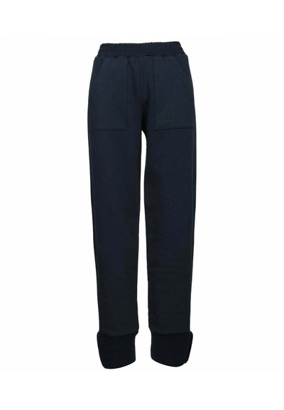 Pantaloni della tuta blu navy con vita elastica, due tasche frontali, polsini a coste e materiale morbido e strutturato. Branding discreto sul davanti.