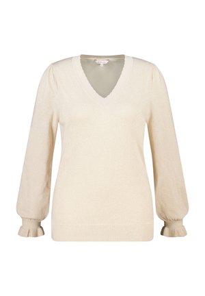 Pull-over beige clair avec col en V, manches bouffantes et poignets à volants. Texture douce avec un léger scintillement. Ourlet côtelé.