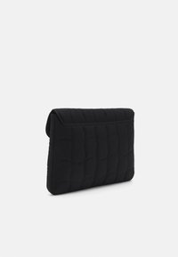 Pochette nera imbottita con una forma strutturata, caratterizzata da un motivo trapuntato testurizzato e una chiusura a pattina. Materiale in morbido tessuto.