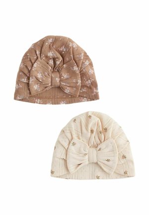 Two soft knit baby hats in floral patterns, one brown and one cream, each featuring a large bow on the front.