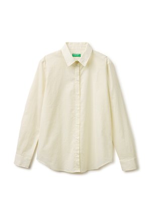 Camicia crema a maniche lunghe con bottoni, piccolo motivo a quadretti e colletto appuntito, distesa su sfondo bianco.