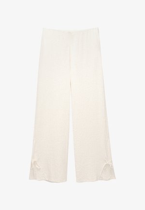 Weite Hosen aus strukturiertem cremefarbenem Stoff; mit elastischem Bund und Bindedetail am Saum, was eine lockere Silhouette schafft.